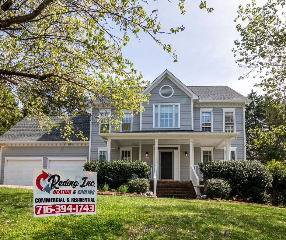 Reding Inc. Heating & Cooling lawn sign displayed in front of a two-story home